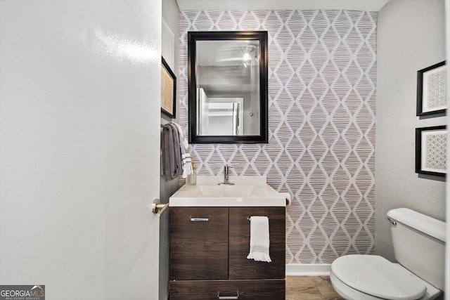 bathroom with toilet and vanity