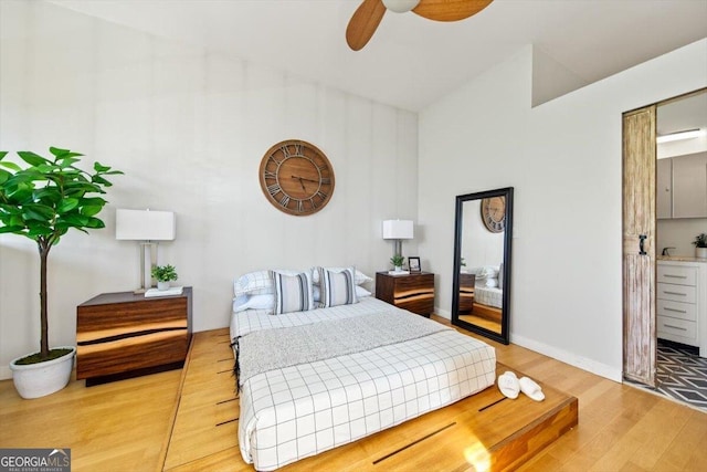 bedroom featuring baseboards and wood finished floors