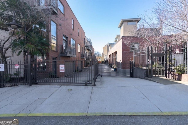 view of street featuring a residential view and a gate