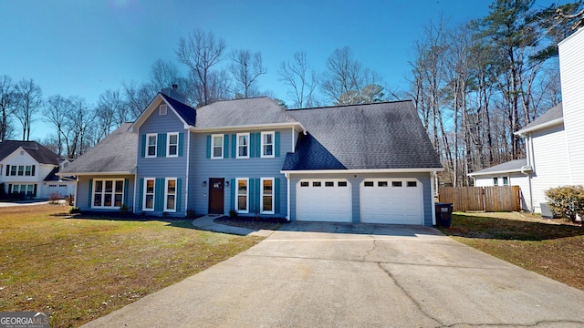 colonial house featuring a chimney, fence, a garage, driveway, and a front lawn