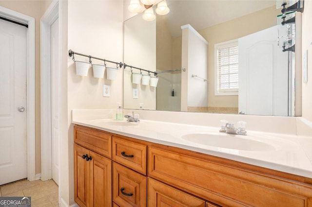 bathroom featuring double vanity, tile patterned flooring, and a sink