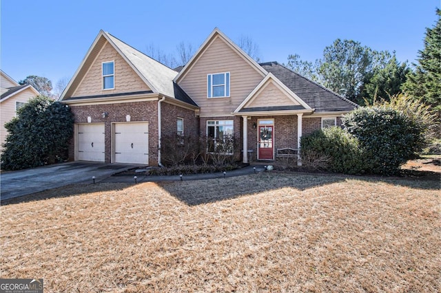 view of front of home with driveway, a garage, and brick siding