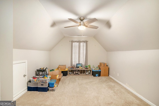 playroom featuring carpet, vaulted ceiling, baseboards, and ceiling fan