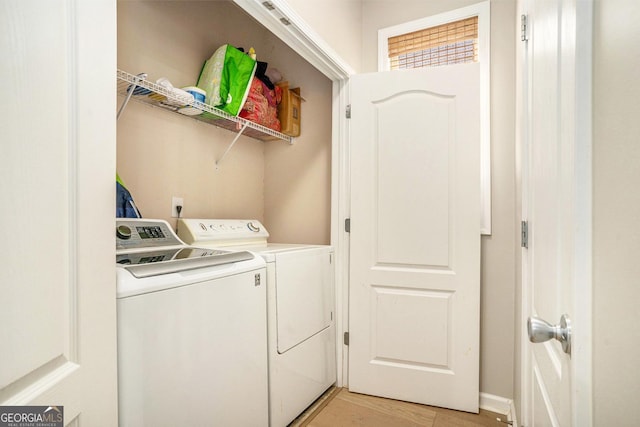 washroom featuring laundry area, light wood-style floors, and washer and dryer