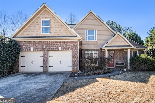 view of front of house featuring an attached garage, concrete driveway, and brick siding