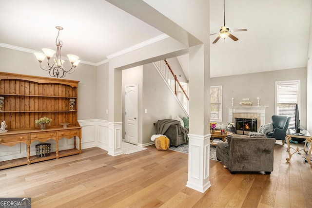 8000 Abington Dr, Locust Grove, GA 30248 - living room with light wood-style floors, a chandelier, ceiling fan, a tile fireplace, and stairs