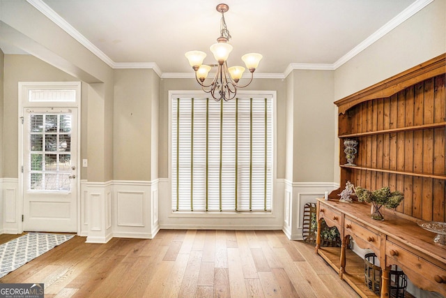 8000 Abington Dr, Locust Grove, GA 30248 - dining area with light wood-style floors, a chandelier, wainscoting, and ornamental molding