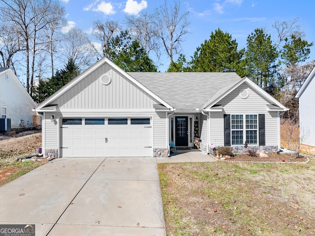 ranch-style house featuring board and batten siding, driveway, an attached garage, and central AC unit