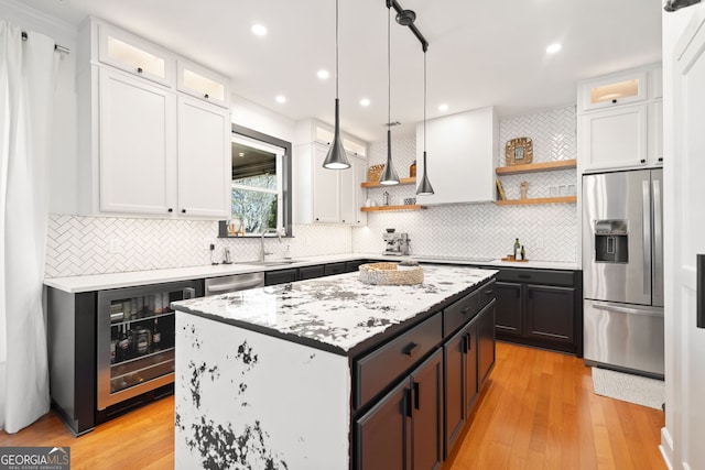 kitchen featuring stainless steel appliances, beverage cooler, white cabinetry, and open shelves