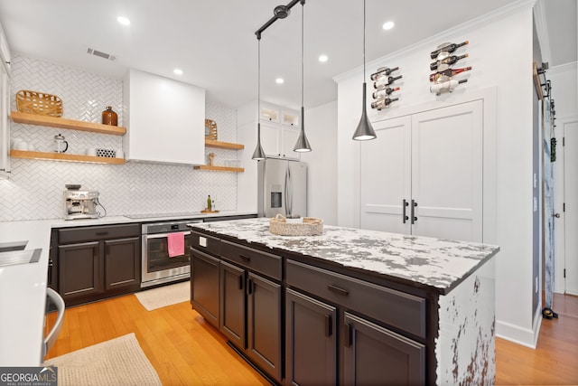 kitchen featuring open shelves, stainless steel appliances, visible vents, dark brown cabinetry, and light wood-type flooring