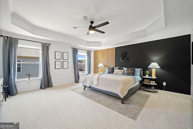 bedroom featuring ornamental molding, carpet floors, a tray ceiling, and baseboards