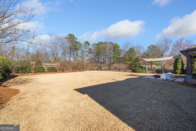 view of yard with fence and a patio