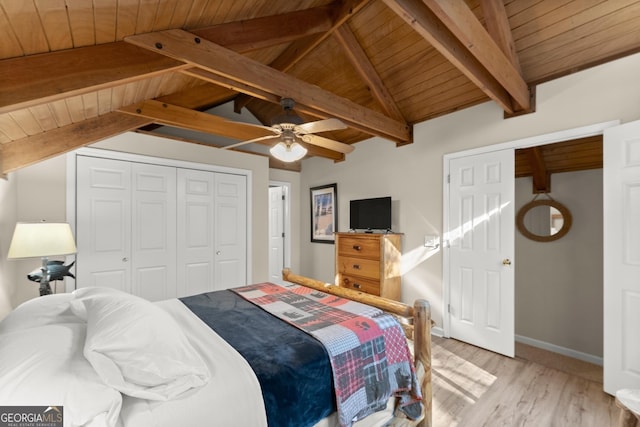 bedroom featuring vaulted ceiling with beams, wood ceiling, baseboards, light wood-style floors, and a closet
