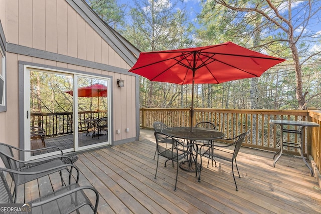 wooden terrace featuring outdoor dining space