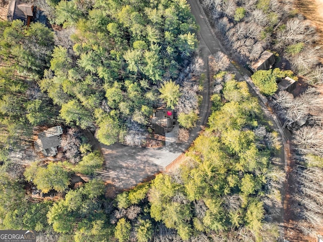 drone / aerial view with a wooded view