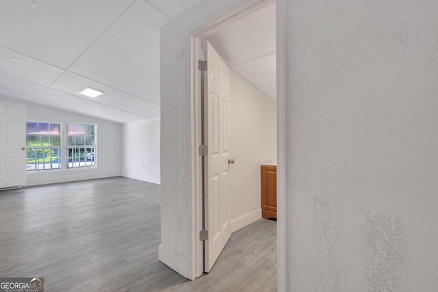 interior space with light wood-type flooring and lofted ceiling