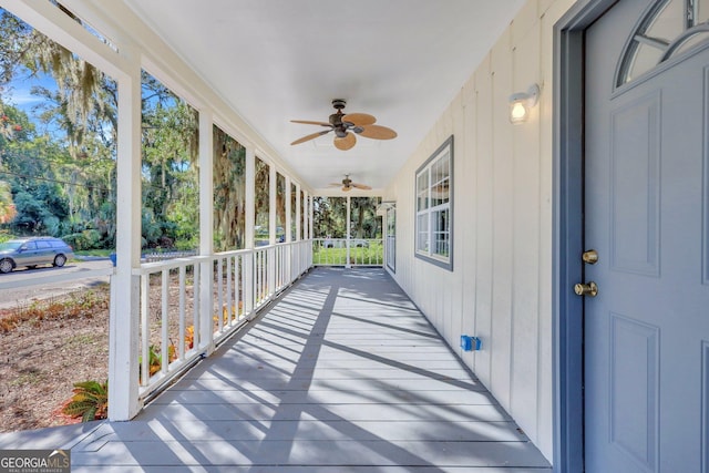 unfurnished sunroom with a ceiling fan