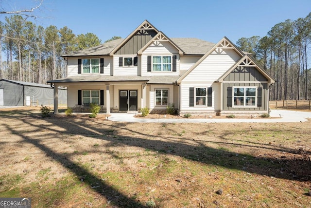view of front of home featuring board and batten siding and a front lawn