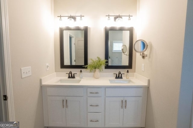 bathroom with a sink and double vanity