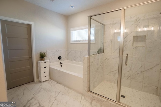 full bath featuring a stall shower, marble finish floor, and a bath