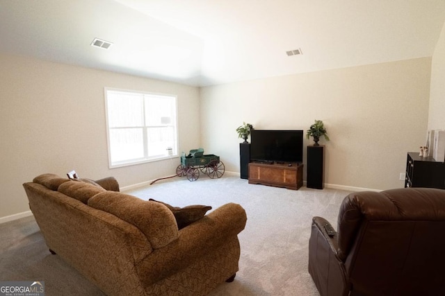 living area with carpet, visible vents, and baseboards