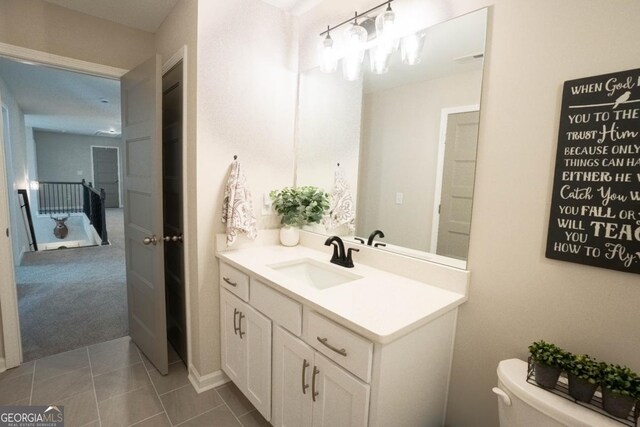 bathroom featuring toilet, tile patterned flooring, visible vents, and vanity