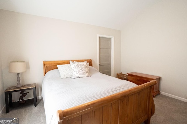 bedroom with light carpet, baseboards, and lofted ceiling