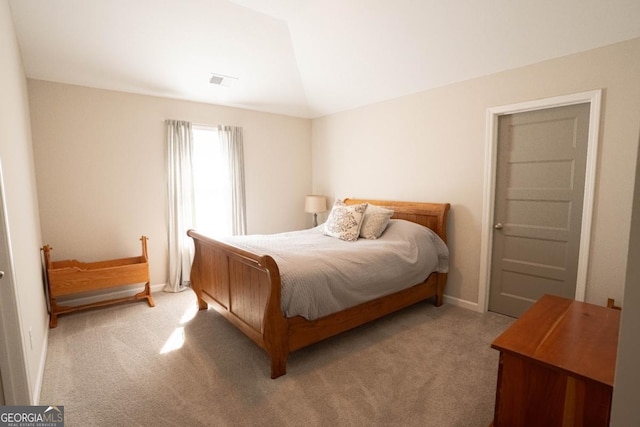 carpeted bedroom featuring visible vents and vaulted ceiling