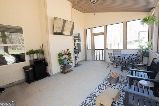sunroom / solarium featuring a ceiling fan and vaulted ceiling