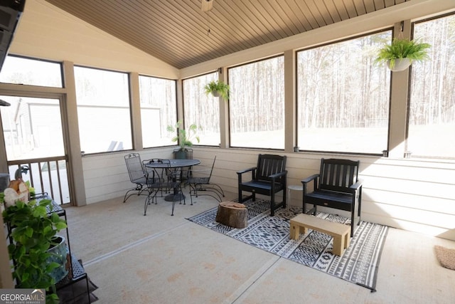 sunroom featuring lofted ceiling and wooden ceiling