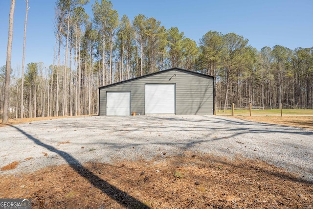 exterior space with a wooded view and fence