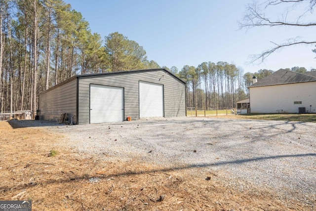 detached garage featuring central AC unit