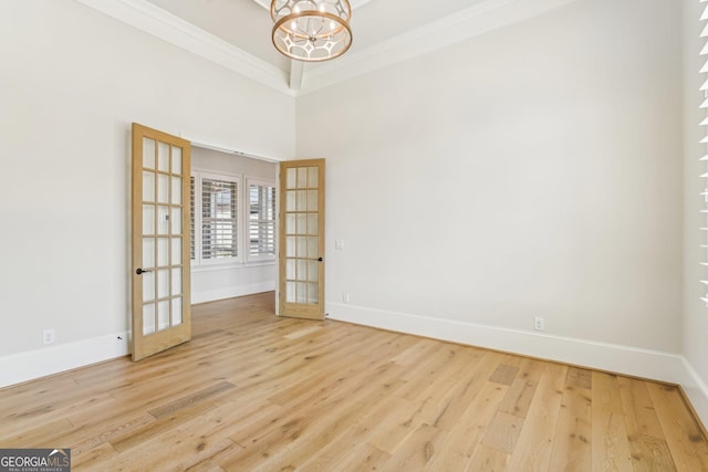 unfurnished room featuring ornamental molding, french doors, baseboards, and wood finished floors