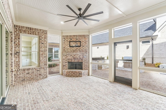 unfurnished sunroom featuring a healthy amount of sunlight and ceiling fan