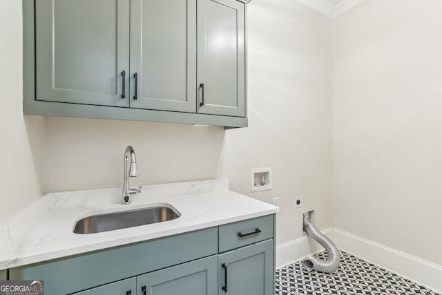 laundry room with washer hookup, cabinet space, hookup for an electric dryer, a sink, and baseboards