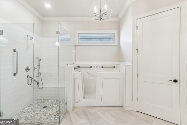 bathroom with a stall shower, ornamental molding, a bath, and an inviting chandelier