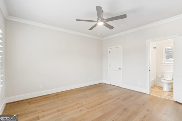 unfurnished bedroom featuring crown molding, baseboards, connected bathroom, and light wood-style floors