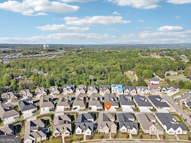 birds eye view of property with a residential view and a view of trees