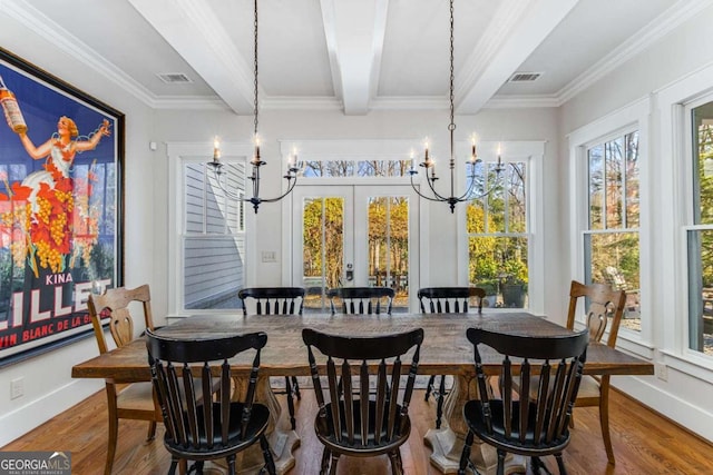 dining space with french doors, a notable chandelier, beamed ceiling, and wood finished floors