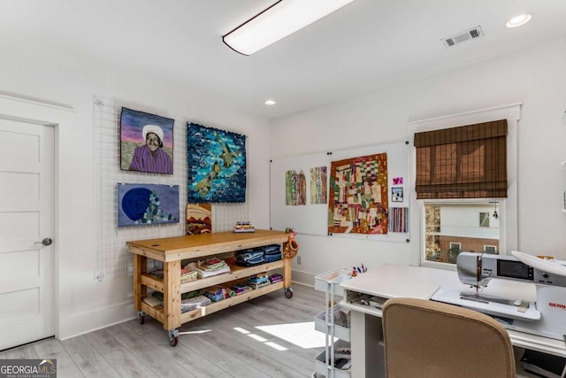 office featuring recessed lighting, light wood-type flooring, visible vents, and baseboards