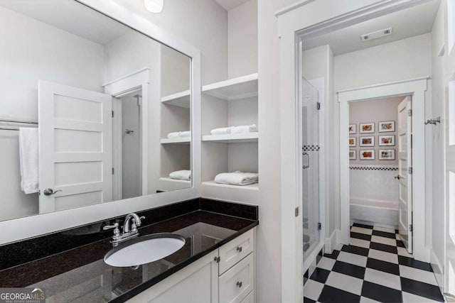 bathroom with a stall shower, vanity, visible vents, and tile patterned floors