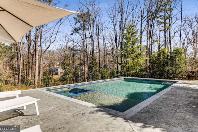 outdoor pool with a patio and fence