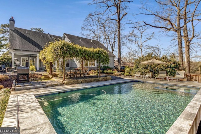 outdoor pool featuring a patio and ceiling fan