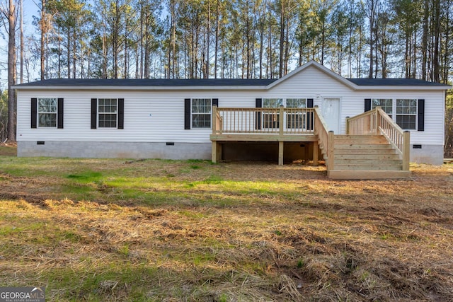 back of property with crawl space, a yard, a wooden deck, and stairs