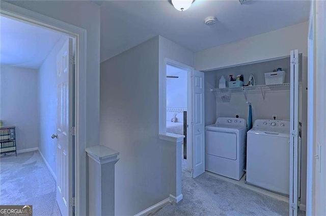 laundry area with laundry area, carpet flooring, washing machine and clothes dryer, and baseboards