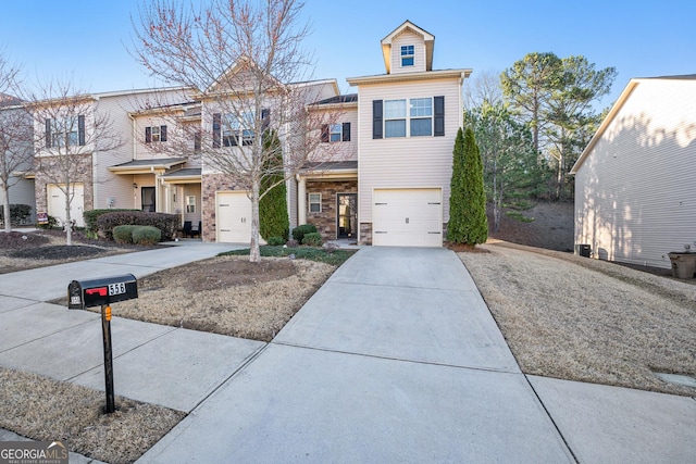 view of property with a garage and driveway