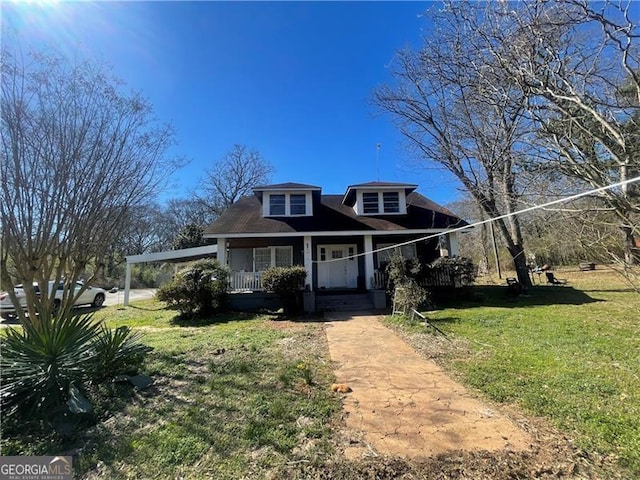 bungalow with a porch and a front lawn