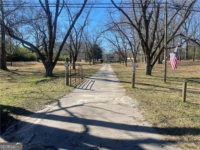 view of road featuring aphalt driveway and a gated entry