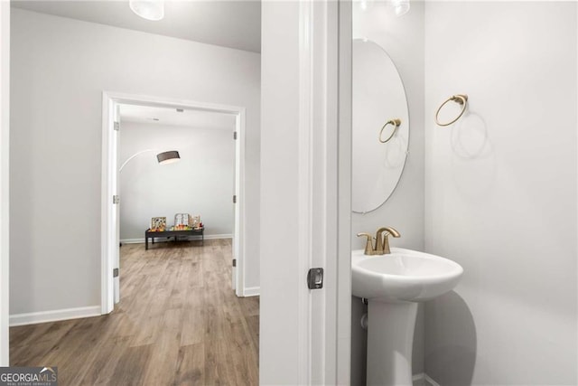 bathroom featuring baseboards and wood finished floors