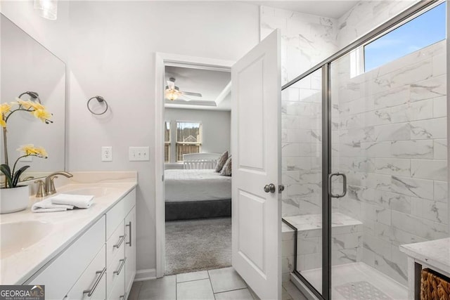 full bath with double vanity, a shower stall, connected bathroom, and a sink